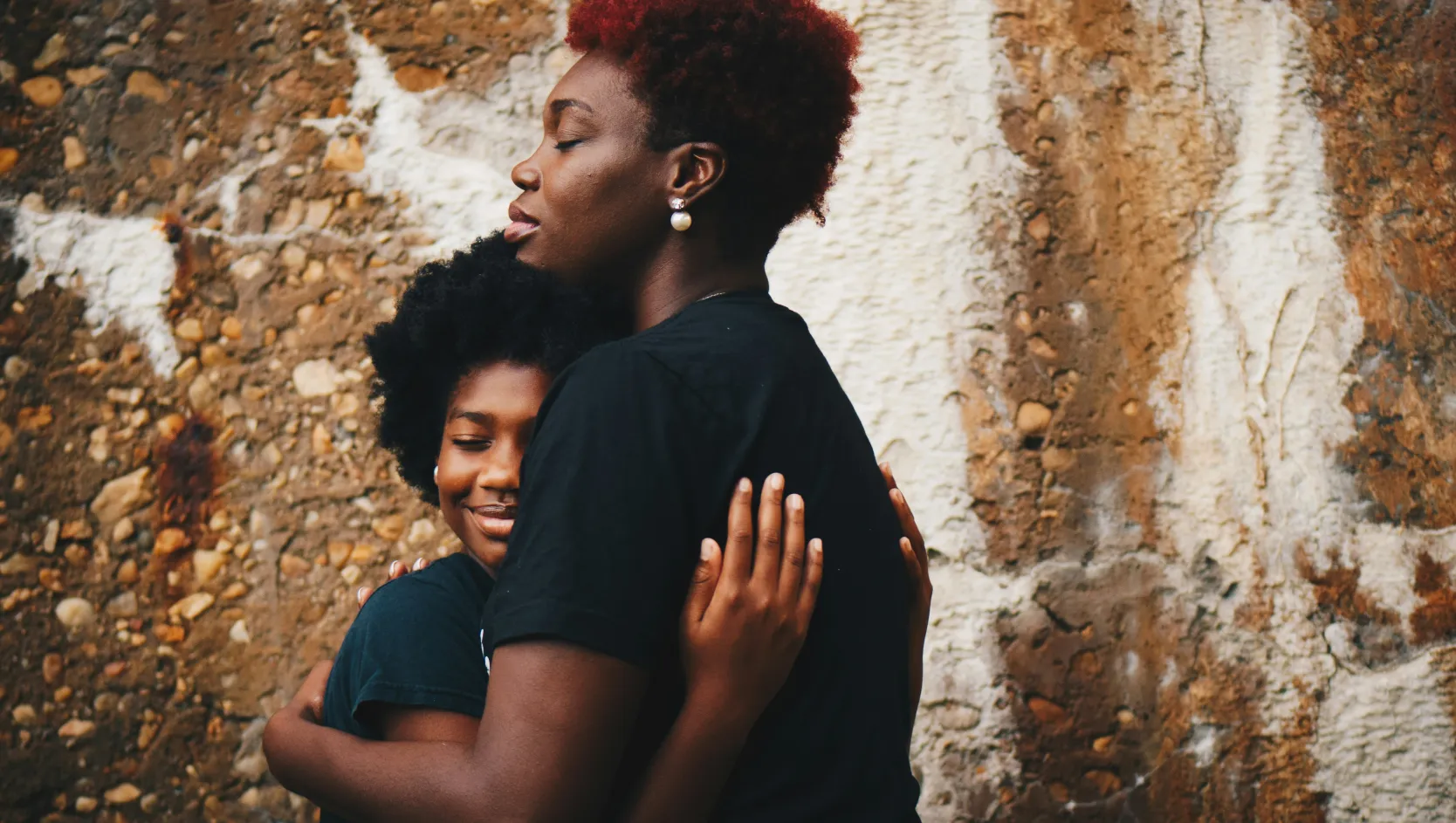 A mother and daughter sharing a reassuring embrace