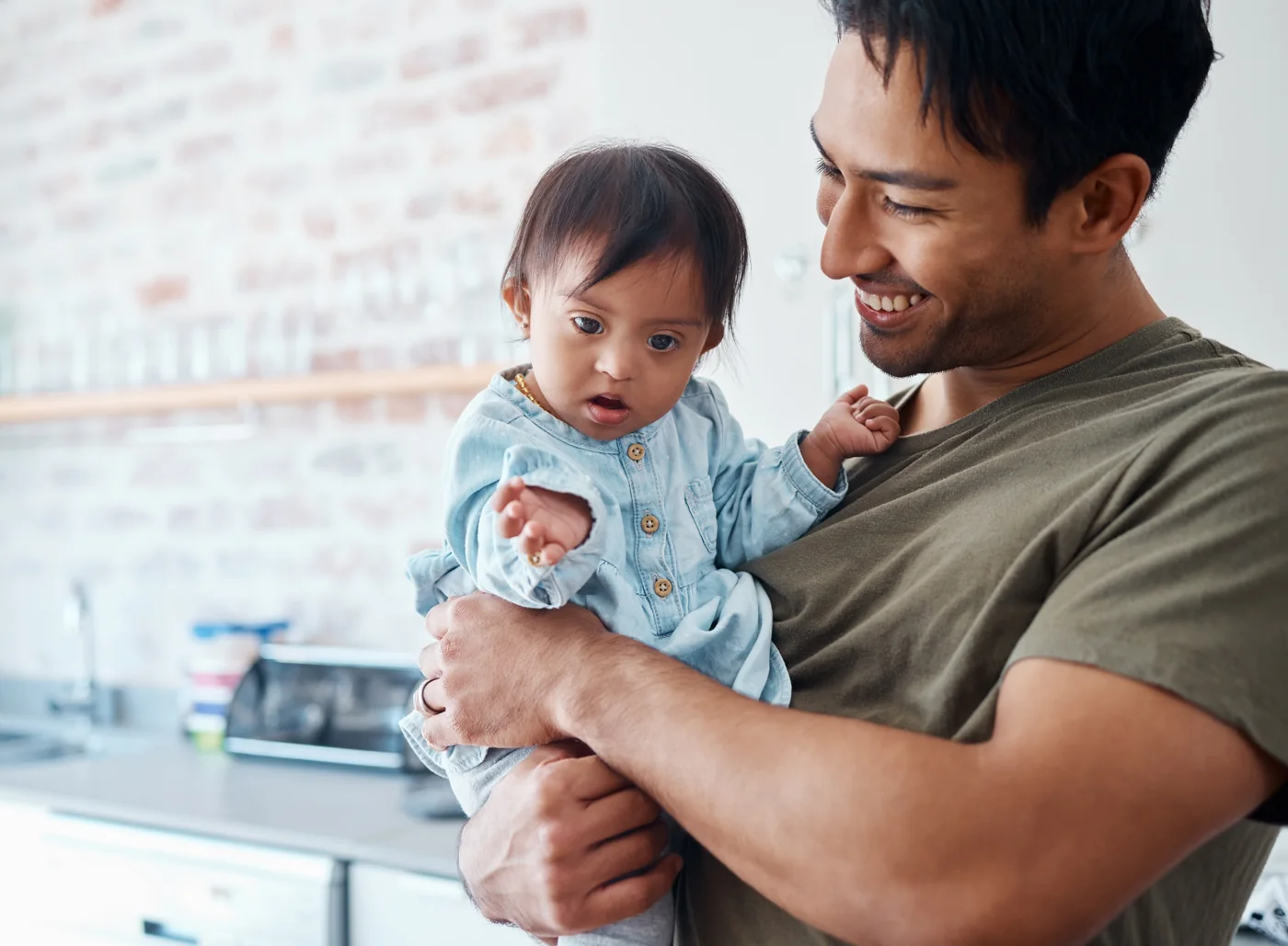Father holding his young child, representing a family navigating divorce with a child who has special needs