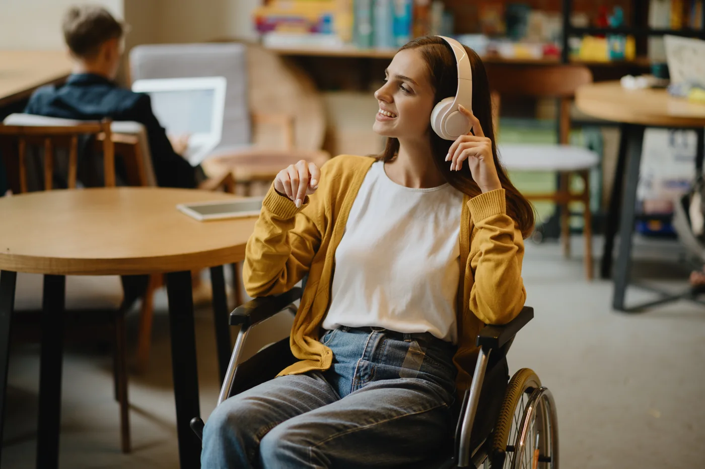 A woman using a wheelchair at a table, getting started with Solagree's special needs divorce process